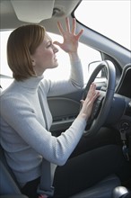Woman driving car honking and gesturing.