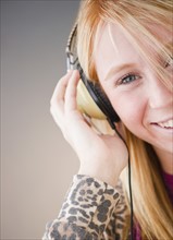 Young woman listening to music. Photo : Jamie Grill Photography