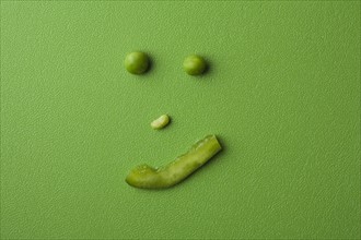 Anthropomorphic face made up from green peas. Photo : Kristin Lee