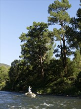 USA, Colorado, Pair of men fly-fishing on mountain river. Photo: John Kelly