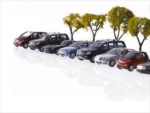 Row of different cars and trees. Photo : David Arky