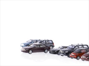 Different parked cars on white background. Photo : David Arky