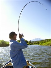 USA, Colorado, Mature man fly-fishing. Photo: John Kelly