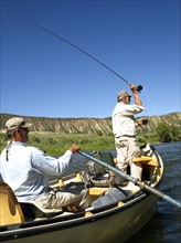 USA, Colorado, Pair of men fly-fishing on mountain river. Photo: John Kelly