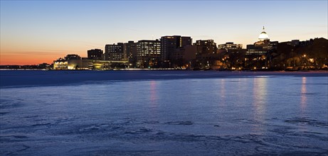 USA, Wisconsin, Madison skyline across frozen lake at dusk. Photo: Henryk Sadura