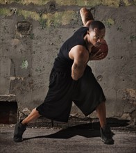 USA, Utah, Salt Lake City, man playing basketball in front of wall. Photo: Mike Kemp