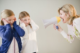 Mother shouting at daughters (8-11) through bullhorn. Photo: Jamie Grill Photography