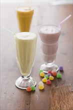 Selection of milk shakes and colorful jelly beans.