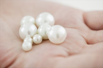 Woman holding pearl.
