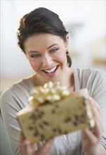 Young woman holding gift.