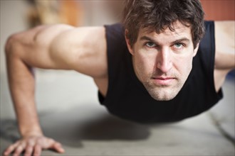 Portrait of man doing push-ups. Photo : Take A Pix Media