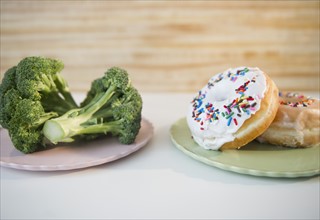 Donuts against broccoli. Photo : Jamie Grill Photography