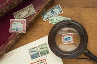 Close up of stamps collection and magnifying glass.