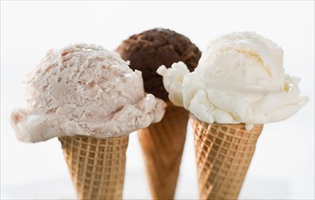 Close up of various ice cream cones.