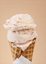 Close up of vanilla ice cream cone.