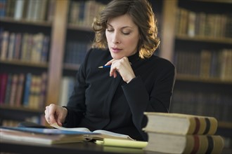 Woman studying at desk in library.