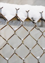 USA, New York State, Brooklyn, Williamsburg, snow covered chainlink fence. Photo: Jamie Grill