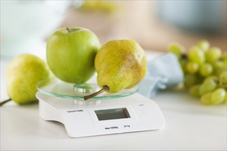 Fresh fruits on weight scale.
