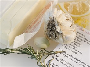 Close-up of butter, garlic, lemon, rosemary and recipe. Photo : Jamie Grill Photography