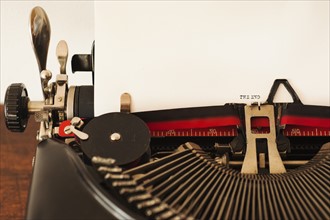 Close up of antique typewriter with "the end" print on page.