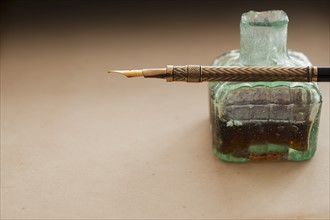 Close up of antique ink well and pen.