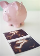 Sonogram picture and piggy bank. Photo : Jamie Grill Photography