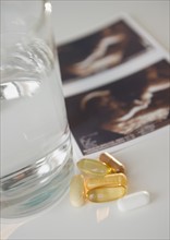 Sonogram picture, pills and glass of water. Photo: Jamie Grill Photography