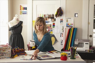 Female fashion designer working in office. Photo : DreamPictures