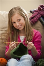 Girl (8-9) knitting woolly hat. Photo: Mike Kemp