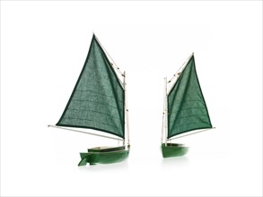 Two toy boats on white background. Photo : David Arky