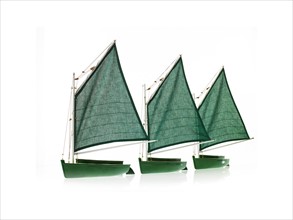 Row of toy boats on white background. Photo: David Arky