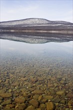 USA, Colorado, Hills reflected in lake. Photo : Noah Clayton