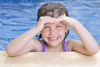 Portrait of smiling girl (6-7) in swimming pool. Photo: Justin Paget