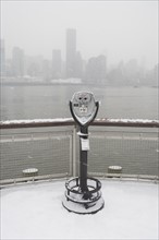 USA, New York City, coin operated binoculars overlooking foggy Manhattan. Photo : fotog
