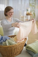 Woman folding laundry.