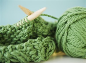 Close-up of green knitwear and yarn. Photo: Jamie Grill Photography