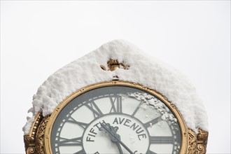 USA, New York, New York City, close up of antique clock covered with snow.