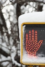 USA, New York, New York City, close up of "don't walk sign" with glowing red hand in winter.