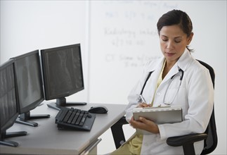 Female doctor making notes.