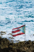 Puerto Rico, Old San Juan, flag of Puerto rice on sea coast.