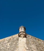 Puerto Rico, Old San Juan, section of El Morro Fortress under blue sky.