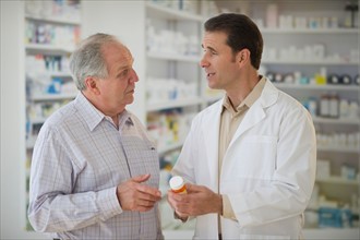 Pharmacist explaining use of medicine to patient.