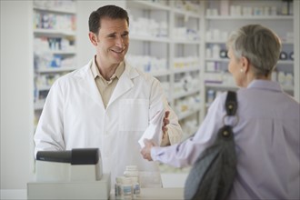 Senior woman talking to pharmacist.