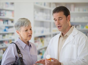 Senior woman talking to pharmacist.