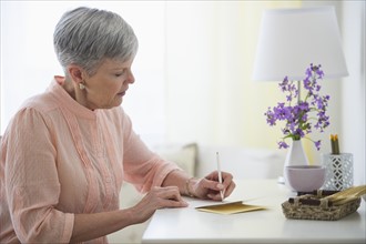 Senior woman writing letter.