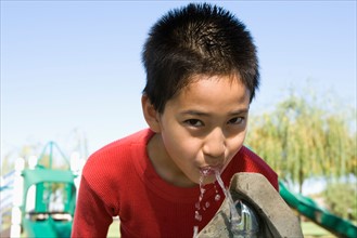 Boy (12-13) at drinking fountain. Photo : Noah Clayton