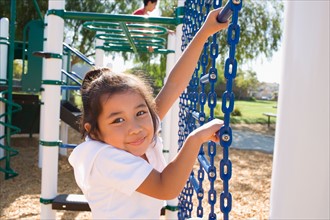 USA, California, Portrait of girl (4-5) climbing at playground. Photo : Noah Clayton