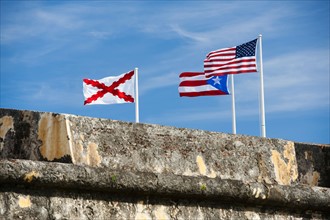 Puerto Rico, Old San Juan, El Morro Fortress, flags behind wall.