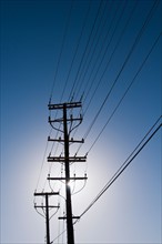 Power line against blue sky. Photo : Daniel Grill