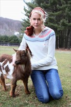 USA, New Jersey, Califon, Young woman at farm with young goat. Photo : Pauline St.Denis